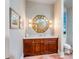 Elegant bathroom showcasing a wooden vanity with marble top, gold mirror, and decorative sconces at 1954 Sandy Point Ln, Mount Pleasant, SC 29466