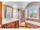 Bright bathroom featuring a glass enclosed shower and soaking tub with wood cabinets at 1954 Sandy Point Ln, Mount Pleasant, SC 29466