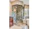 Bathroom with a marble shower, patterned tile floor, elegant lighting, and sophisticated fixtures at 1954 Sandy Point Ln, Mount Pleasant, SC 29466