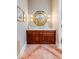 Elegant bathroom showcasing a wooden vanity with marble top, gold mirror, and decorative sconces at 1954 Sandy Point Ln, Mount Pleasant, SC 29466