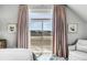 Bright bedroom with private balcony access, luxury fabrics, and view of the marsh at 1954 Sandy Point Ln, Mount Pleasant, SC 29466