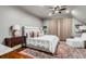Comfortable bedroom with a ceiling fan, stylish curtains, a queen bed and a chair at 1954 Sandy Point Ln, Mount Pleasant, SC 29466