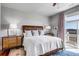 Beautiful bedroom with a balcony, hardwood floors and luxurious bedding at 1954 Sandy Point Ln, Mount Pleasant, SC 29466