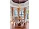 Dining area with scenic views, featuring a wooden table with upholstered chairs and decorative lighting at 1954 Sandy Point Ln, Mount Pleasant, SC 29466