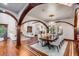 Open-concept dining room showcasing a long table, hardwood floors, and seamless access to the living room at 1954 Sandy Point Ln, Mount Pleasant, SC 29466