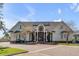 Stately home featuring a brick driveway, manicured lawn, and inviting facade with elegant columns at 1954 Sandy Point Ln, Mount Pleasant, SC 29466