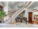 Elegant foyer with grand staircase and piano at 1954 Sandy Point Ln, Mount Pleasant, SC 29466