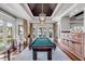 Bright game room with a pool table, tray ceiling and a stunning view at 1954 Sandy Point Ln, Mount Pleasant, SC 29466
