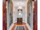 Hallway with hardwood floors, lighting fixture, and artwork on the walls at 1954 Sandy Point Ln, Mount Pleasant, SC 29466