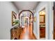 Hallway with wood floors, arched entryways, ornate furnishings, and a view into adjacent rooms at 1954 Sandy Point Ln, Mount Pleasant, SC 29466