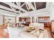 Open concept living room and kitchen with exposed ceiling beams and white furnishings at 1954 Sandy Point Ln, Mount Pleasant, SC 29466
