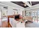 Bright living room featuring water views and fireplace with custom wood surround at 1954 Sandy Point Ln, Mount Pleasant, SC 29466