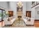 Elegant living room with fireplace, chandelier, hardwood floors, and stylish furniture at 1954 Sandy Point Ln, Mount Pleasant, SC 29466