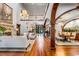Open-concept living and dining area with hardwood floors, grand staircase, and elegant lighting at 1954 Sandy Point Ln, Mount Pleasant, SC 29466