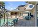 Inviting pool area with outdoor kitchen, seating, and a beautiful home exterior at 1954 Sandy Point Ln, Mount Pleasant, SC 29466