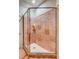 Luxurious marble-tiled shower with a frameless glass enclosure and custom shelving at 1954 Sandy Point Ln, Mount Pleasant, SC 29466