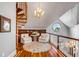 Cozy sitting area featuring a spiral staircase, custom built-in bookshelves, and round window with water view at 1954 Sandy Point Ln, Mount Pleasant, SC 29466