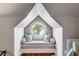 A cozy window seat framed by a round window, perfect for relaxation, with custom cushions and natural light at 1954 Sandy Point Ln, Mount Pleasant, SC 29466