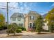 Charming two-story home with a quaint front porch and manicured landscaping at 21 Rutledge Ave, Charleston, SC 29401
