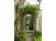 Enchanting garden entrance with lush greenery, a stone archway, and a glimpse of the serene backyard at 21 Rutledge Ave, Charleston, SC 29401