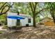 Inviting backyard area features a white home, lovely landscaping, and mature shade trees at 2122 Commander Rd, North Charleston, SC 29405