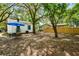 Well-maintained backyard featuring a patio set and partially shaded by mature trees at 2122 Commander Rd, North Charleston, SC 29405