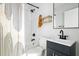 Modern bathroom with subway tile, black fixtures, wooden shelving, and a unique shower curtain design at 2122 Commander Rd, North Charleston, SC 29405