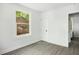 Bright bedroom with wood floors and a large window offering views of the neighborhood, creating a cozy atmosphere at 2122 Commander Rd, North Charleston, SC 29405