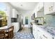 Efficient kitchen with white cabinets, granite countertops, stainless steel appliances, and a casual dining space at 2122 Commander Rd, North Charleston, SC 29405