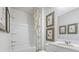 Clean bathroom featuring a bathtub/shower combo, white vanity, and tasteful decor offers a fresh and modern space at 2324 Macallan Blvd, Ravenel, SC 29470
