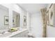 Clean bathroom featuring double sinks, white cabinetry, framed art, coordinated fixtures and tub with shower at 2324 Macallan Blvd, Ravenel, SC 29470