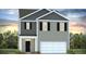 Two story home with a two car garage, grey siding, dark shutters, and a landscaped front yard at 2324 Macallan Blvd, Ravenel, SC 29470