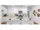 Modern white kitchen featuring granite countertops, stainless steel appliances, and a stylish island with a sink at 2324 Macallan Blvd, Ravenel, SC 29470