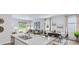 Bright kitchen with island, stainless appliances, granite countertops, and modern decor open to dining and living area at 2324 Macallan Blvd, Ravenel, SC 29470