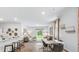 Open-concept living and dining areas showcasing hardwood floors and modern decor with a large sliding door to the backyard at 2324 Macallan Blvd, Ravenel, SC 29470