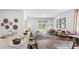Living area showcasing the kitchen island, hardwood floors, decor, and a sliding door to the backyard at 2324 Macallan Blvd, Ravenel, SC 29470