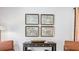 Well-appointed living room with artwork and modern console table and comfortable seating is perfect for relaxing at 2324 Macallan Blvd, Ravenel, SC 29470