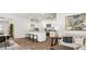 Open-concept living space with a modern kitchen, dining area, and living room features plenty of natural light and style at 2324 Macallan Blvd, Ravenel, SC 29470