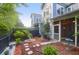 Well-maintained backyard with stone pathway, mulched areas, garden, and a black privacy fence at 2338 Kings Gate Ln, Mount Pleasant, SC 29466