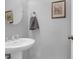 Bright half bathroom with a pedestal sink, gray walls and a decorative framed print at 2338 Kings Gate Ln, Mount Pleasant, SC 29466