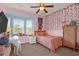 Whimsical bedroom featuring pink walls and a decorative bay window at 2338 Kings Gate Ln, Mount Pleasant, SC 29466
