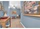 Hallway with blue walls with neutral living space, stylish furnishings, and ceiling fan beyond at 2338 Kings Gate Ln, Mount Pleasant, SC 29466