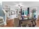 Bright living room featuring built-in shelves, hardwood floors, ceiling fan, and stylish furniture at 2338 Kings Gate Ln, Mount Pleasant, SC 29466