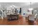 Open-concept living room with hardwood floors, built-in shelves, and a dining area at 2338 Kings Gate Ln, Mount Pleasant, SC 29466