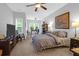 Comfortable bedroom suite with a sitting area, large windows, and a ceiling fan providing great light at 2338 Kings Gate Ln, Mount Pleasant, SC 29466
