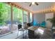 Inviting screened porch features wood paneling, comfortable seating, ceiling fan, and views of a landscaped yard at 2338 Kings Gate Ln, Mount Pleasant, SC 29466