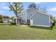 Expansive backyard features a covered patio, lush green grass, and privacy fencing at 2568 Hatch Dr, Johns Island, SC 29455