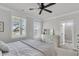 Bright bedroom with large windows, ceiling fan and access to en-suite bath at 2568 Hatch Dr, Johns Island, SC 29455