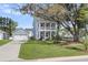 Charming home featuring a two-story porch, garage, and manicured lawn at 2568 Hatch Dr, Johns Island, SC 29455