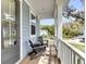 Relaxing covered porch features chairs, wooden floors, and a view of the neighborhood at 2568 Hatch Dr, Johns Island, SC 29455